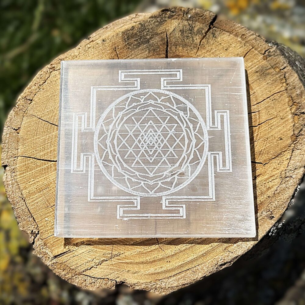 Front view of Shree Yantra engraved Selenite charging plate on wooden block